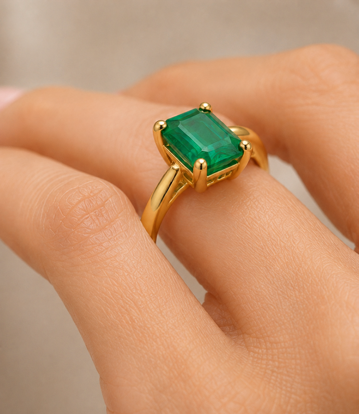 The Bishop — emerald cut emerald solitaire ring, 18k yellow gold, styled flat lay